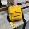 Bright yellow canvas crossbody bag with black wide strap and front pocket detail - Yellow