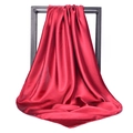 Detail of red satin silk square scarf with high gloss finish on black display frame - Burgundy