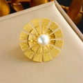 Elegant gold sunflower ring with center pearl on beige textured gift box backdrop - White Pearl Ring (R491)