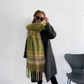 Classic green plaid mohair scarf with tassels worn by model for winter warmth - Green