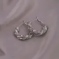 Silver twisted hoop earrings with a dense spiral design on elegant purple satin fabric - E-072---Platinum