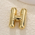 Detailed macro of gold-plated puffy letter H balloon pendant with polished mirror finish - Letter H