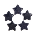 Macro shot of five blue sandstone star-shaped charms with sparkling finish on white background - Blue Sandstone
