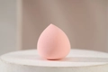 Pink teardrop makeup sponge made of soft foam on a minimalist pedestal base - Single Pink Waterdrop