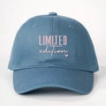 Close-up of pink LIMITED edition lettering and heart embroidery on navy cotton baseball cap - One Size / Blue