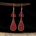 Detail of Pipa-shaped earrings with red enamel flowers and golden ornate borders - Dark Red Gold Edge Pipa