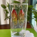Macro detail of red and yellow gradient cicada wing earrings with gold foil accents - Orange Gold Foil