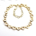 Detail of heart-shaped gold bracelet featuring sparkling zircon accents and adjustable clasp - Hollow Heart / Gold