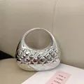 Silver mirror shell bag with quilted texture and sleek circular handle design - Silver