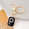 Detail of Letter P keychain featuring black enamel gold metal and sparkling rhinestones - Letter P