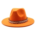 Close-up of orange wool felt fedora with brown snake pattern leather band and gold stud detail - Orange