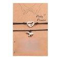 Close-up of dinosaur charms on woven bracelets with Pinky Promise display card - Black Rope