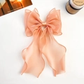 Detail of soft peach organza bow hair clip with long ribbons on a white background - Shiny Silk Ribbon Bow / Orange Red