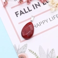 Faceted red stone water drop pendant with silver clasp on a white decorative card - Red Jasper