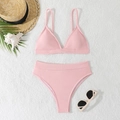 Light pink waffle textured two-piece bikini set with high-waisted bottoms on white decor - S / Pink