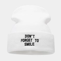 Detail of the black embroidered Don't Forget To Smile text on a white knit beanie - White