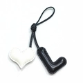 Handmade leather heart and letter L bag charm with stitched edges on black cord - Black L with Off-white Heart