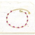 Macro detail of gold-plated bracelet with magenta stone beads and adjustable chain clasp - Rose Red Round Beads Interspersed Gold Chain