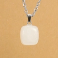 Vertical view of a square white stone pendant with a silver chain against a yellow backdrop - Silver & White Crystal