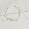 Detail of bohemian handmade beaded bracelet with white natural stones and adjustable cord - Howlite