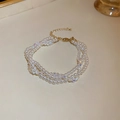 Three-layer pearl and crystal bracelet with golden adjustable clasp and extension chain - White Crystal
