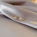 Elegance 14k gold plated starburst ear cuffs with zircon inlays on gray silk fabric - 35017-Gold Octagonal Star Rhinestone Pair