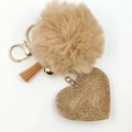 Detail of light brown faux fur pom pom keychain with sparkling golden rhinestone heart - Khaki