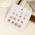 Detailed set of 9 pairs rose gold earrings featuring pearls and crystals on card - Set 5 [Footprint + Quadrilateral]