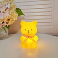 Warm glow yellow bear night light with red ribbon in a cozy home decor setting - Small Bear Yellow - Blue