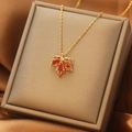 Golden maple leaf pendant necklace with orange gemstones in a luxury brown jewelry box - Red Maple Leaf Necklace (X5415)