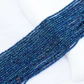Macro detail of 2mm faceted crystal beads with deep blue electroplated metallic finish - 2mm (Approx. 210 Beads per Strand) / Blue Luster