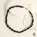 Detailed macro of black gemstone chip necklace with golden beads and lobster clasp - Obsidian Color (NE2134-G)