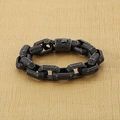 Macro view of vintage stainless steel chain bracelet with intricate floral engravings - 21cm / Matte Black