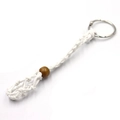 Handmade white woven net keychain with a brown wooden bead and metal ring loop - White
