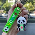 Detail of cute panda keychain holding a green mahjong tile with gold metal ring - Panda Gen 4 - Style 01