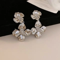 Close-up of silver flower drop earrings featuring textured petals on black velvet background - Silver Flower Dangle / Silver