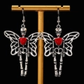 Detailed view of Gothic earrings featuring skull butterfly wings and red heart charms - Silver Butterfly Skull Style (G032)