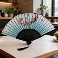 Classical folding fan with blue gradient silk, plum blossoms, and elegant black tassel - Style 42 (New Style)