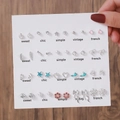 Dettagli di 20 paia di orecchini in argento con perle e motivi a cuore e fiocco - E1692-1