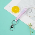 Light purple iridescent PVC strap keychain with silver lobster clasp on desk surface - Holographic Light Pink