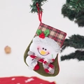 Detail of green felt Christmas stocking with snowman pattern and red plaid cuff decoration - Small Plaid Cuff Snowman Stocking