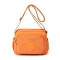 Vibrant orange waterproof nylon crossbody bag with multiple zip pockets and side pouches - Honey Orange