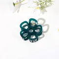 Close-up of a dark green resin flower hair claw clip with a spring mechanism - Hollow Five-Petal Flower - Jelly Emerald Green