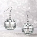 Close-up of silver disco ball earrings with faceted mirror finish on a sparkly base - Silver