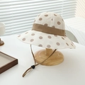 Detail of polka dot sun hat featuring an adjustable brown chin strap and toggle - 52cm (2-5 Years) / Brown