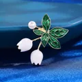 Elegant lily of the valley brooch with green enamel leaves and a white pearl accent - White Lily of the Valley