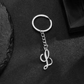 Polished stainless steel keychain with letter L pendant on dark stone background - L