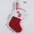 Red knitted Christmas stocking with embroidered letter R and specific size details. - Letter R