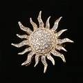Elegant gold sunburst brooch with sparkling white rhinestones on black background - XD10853 Golden Sunbeam