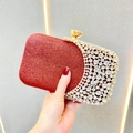 Close-up of red glitter evening bag with sparkling rhinestones and golden metal clasp - Burgundy